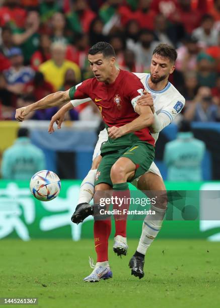 Former Juventus team mates Rodrigo Bentancur of Uruguay and Cristiano Ronaldo of Portugal battle for the ball during the FIFA World Cup Qatar 2022...