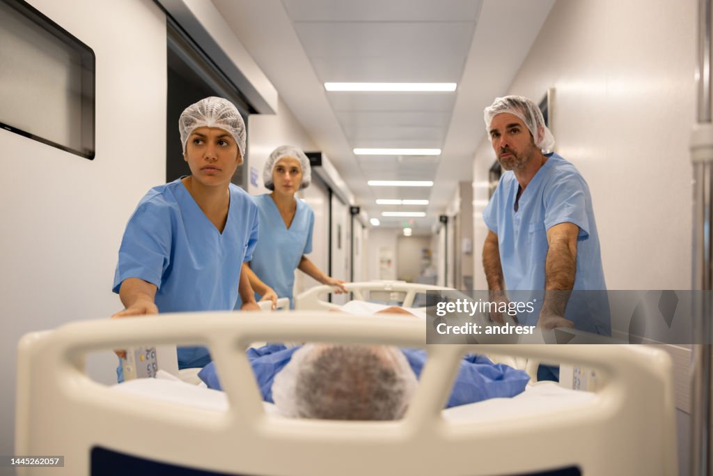 Patient Rushed Team Of Doctors Rushing A Patient Into Surgery High-Res Stock Photo ...