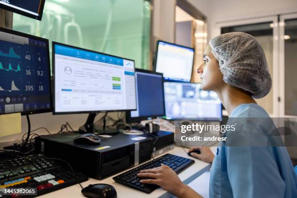 doctor in the control room looking at a medical scan - scientific imaging technique stock pictures, royalty-free photos & images