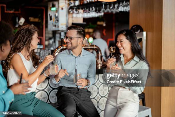 multiracial friends having fun in the cafe - bar atmosphere stock pictures, royalty-free photos & images
