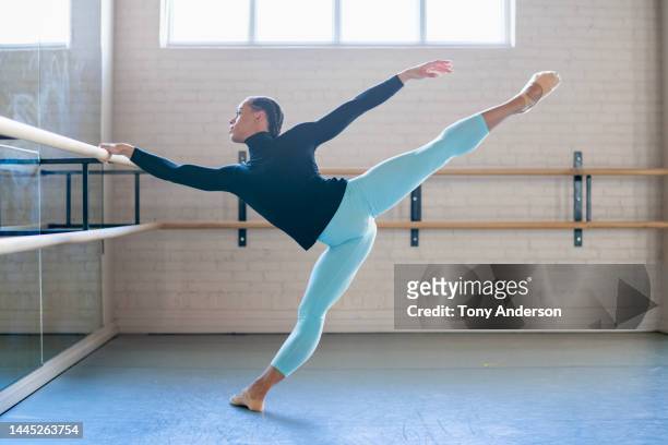 young man ballet dancer working in dance studio - ballerinas stock-fotos und bilder
