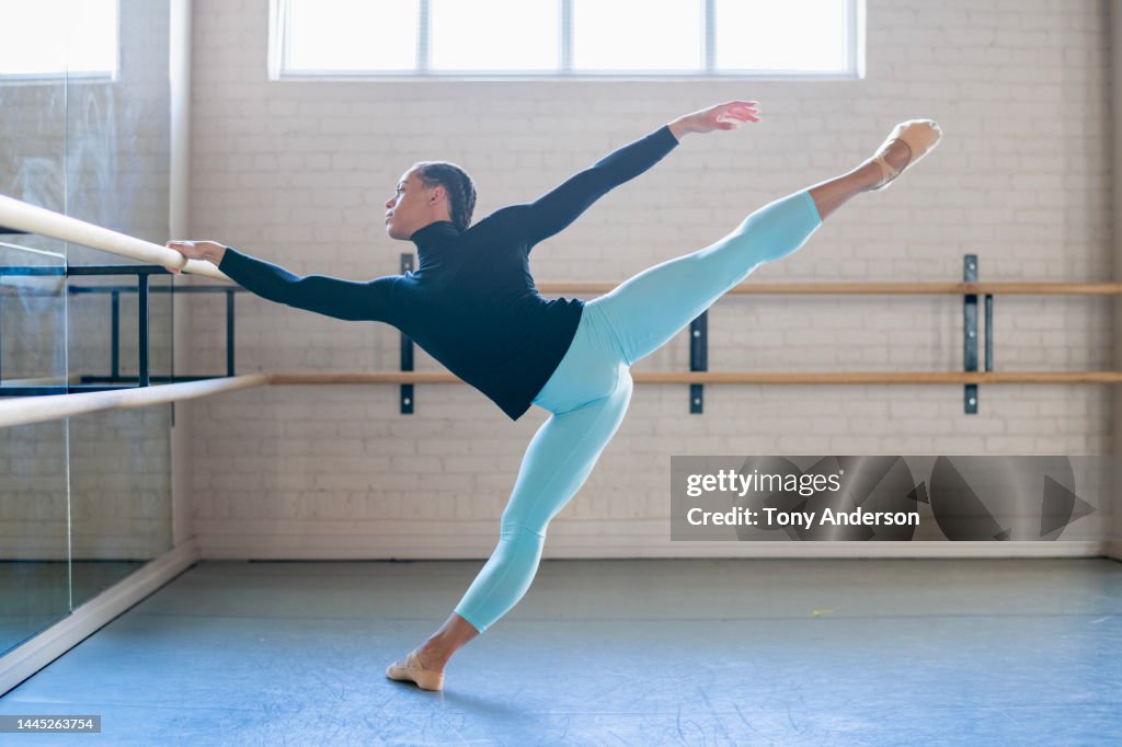 Young man ballet dancer working in dance studio