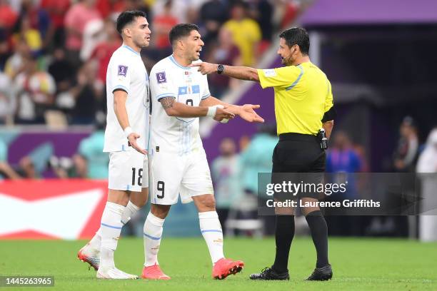 Luis Suarez of Uruguay argues with referee Alireza Faghani during the FIFA World Cup Qatar 2022 Group H match between Portugal and Uruguay at Lusail...