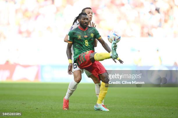 Andre-Frank Zambo Anguissa of Cameroon controls the ball under pressure of Nemanja Maksimovic of Serbia during the FIFA World Cup Qatar 2022 Group G...