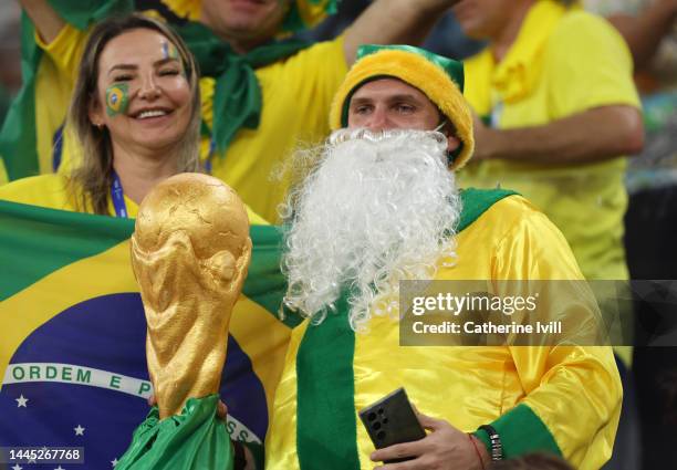 Fans of Brazil and Switzerland wearing Christmas outfits with a home made World Cup trophy during the FIFA World Cup Qatar 2022 Group G match between...