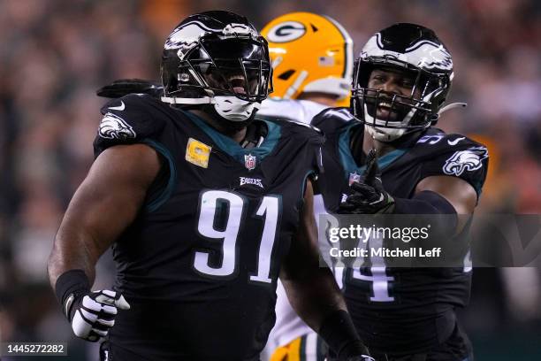 Fletcher Cox of the Philadelphia Eagles reacts along with Josh Sweat against the Green Bay Packers at Lincoln Financial Field on November 27, 2022 in...