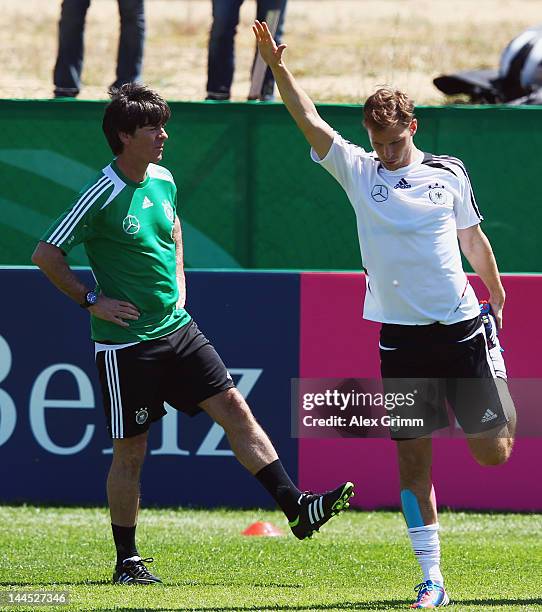 Head coach Joachim Loew watches Benedikt Hoewedes during a Germany training session at Campo Sportivo Comunale Andrea Dora on May 15, 2012 in Olbia,...