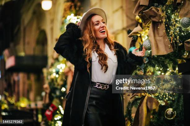 smiling fashion woman enjoying christmas in city - christmas background no people stock pictures, royalty-free photos & images