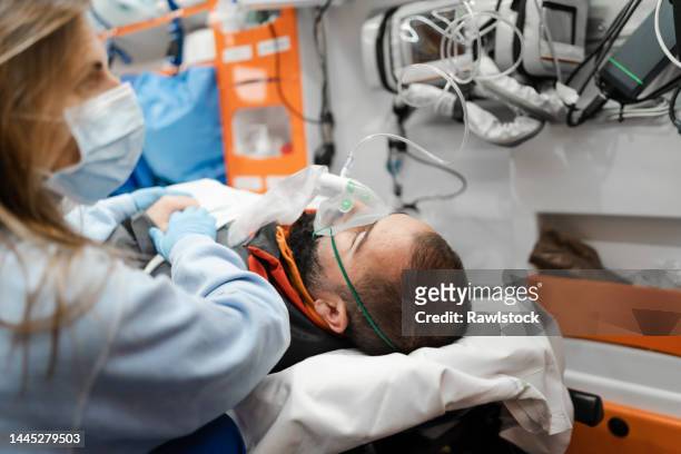 healthcare workers saving a life - ambulance staff stock pictures, royalty-free photos & images