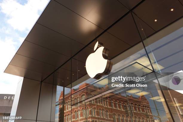 The Apple company logo hangs above an Apple retail store on November 28, 2022 in Chicago, Illinois. Apple is currently facing shortages in iPhone...