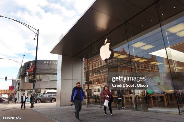 The Apple company logo hangs above an Apple retail store on November 28, 2022 in Chicago, Illinois. Apple is currently facing shortages in iPhone...