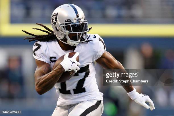 Davante Adams of the Las Vegas Raiders carries the ball against the Seattle Seahawks during the fourth quarter at Lumen Field on November 27, 2022 in...