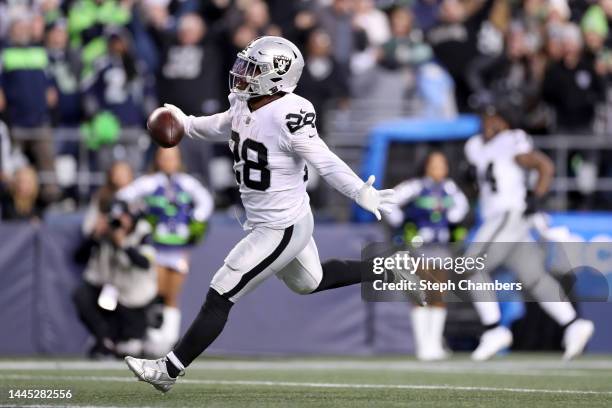 Josh Jacobs of the Las Vegas Raiders celebrates after scoring a touchdown in overtime to beat the Seattle Seahawks 40-34 at Lumen Field on November...