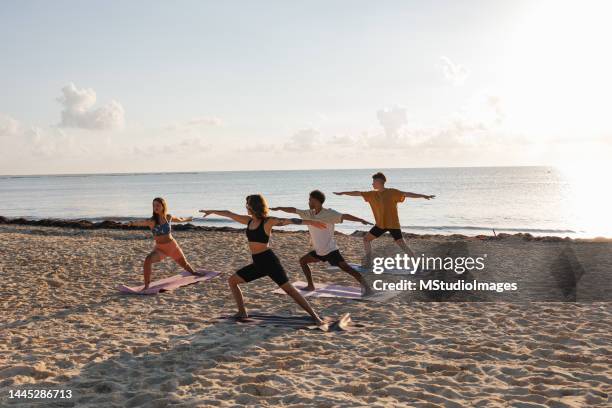 yoga class at the beach - sunrise yoga stock pictures, royalty-free photos & images