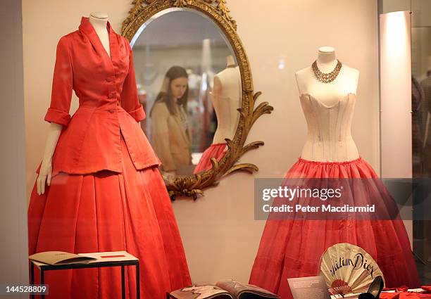 Christian Dior designs are displayed at the 'Ballgowns: British Glamour Since 1950' exhibition at The Victoria and Albert Museum on May 15, 2012 in...