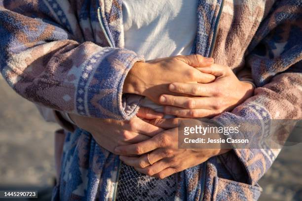 close up of two women's hands embracing - hands embracing stock pictures, royalty-free photos & images