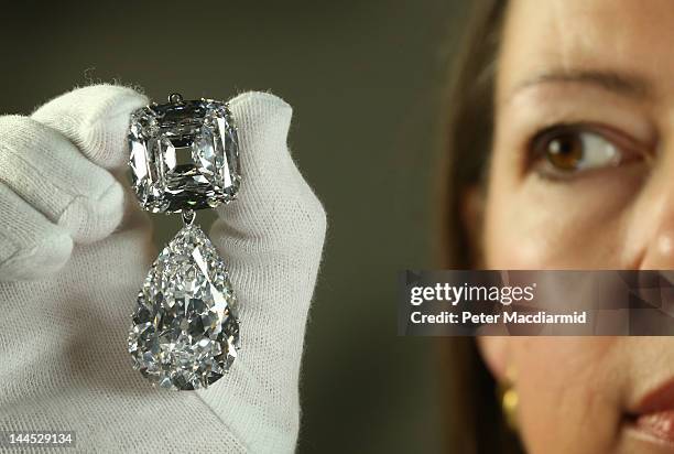 Caroline de Guitaut, Curator of Royal Collections, holds the Cullinan III and IV Broach at The Queen's Gallery, Buckingham Palace on May 15, 2012 in...