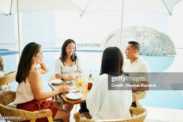 medium shot of family seated for breakfast at outdoor restaurant - exclusive travel stock pictures, royalty-free photos & images