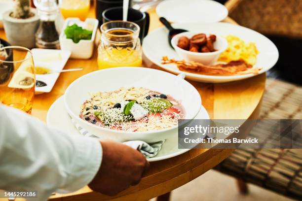 close up shot of waiter delivering breakfast to table - serving dish stock pictures, royalty-free photos & images
