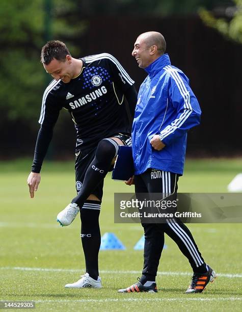 Roberto Di Matteo caretaker manager of Chelsea shares a joke with John Terry during training at Chelsea Training Ground on May 15, 2012 in Cobham,...
