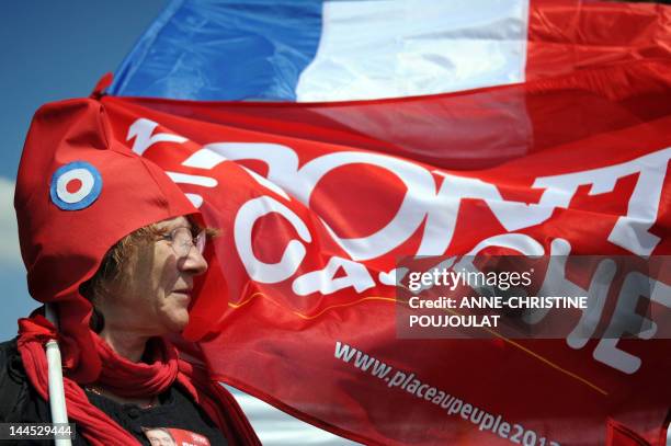 Supporter of French Front de Gauche leftist party's presidential candidate takes part in a campaign meeting on April 14, 2012 at the Plage du Prado...