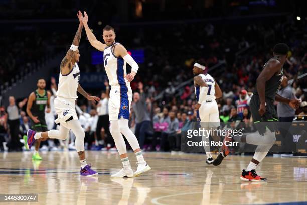Kristaps Porzingis celebrates after hitting a three pointer in the first half with teammate Kyle Kuzma of the Washington Wizards against the...