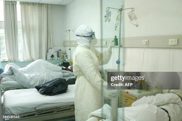 Nurse checks fluids in an isolation ward for Severe Acute Respiratory Syndrome patients, 17 April 2003, in Beijing's Ditan Hospital. China's...