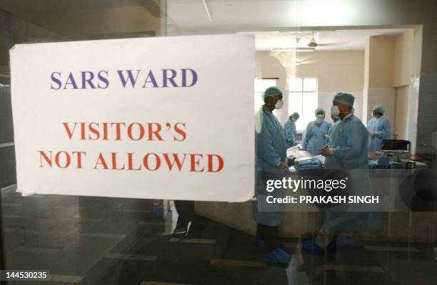 Doctors and hospital staff talk inside the newly built special wards for Severe Acute Respiratory Syndrome patients at the Infectious Disease...