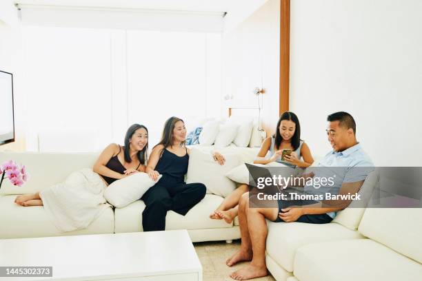 wide shot of family relaxing in luxury hotel suite while on vacation - open day 4 stockfoto's en -beelden