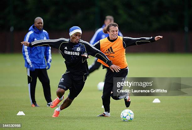 Didier Drogba and David Luiz of Chelsea compete for the ball during aining at Chelsea Training Ground on May 15, 2012 in Cobham, England.