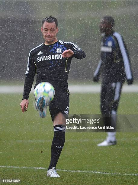 John Terry of Chelsea controls the ball in the rain during training at Chelsea Training Ground on May 15, 2012 in Cobham, England.