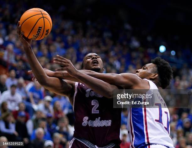 Davon Barnes of the Texas Southern Tigers goes up for a shot and is fouled by MJ Rice of the Kansas Jayhawks in the second half at Allen Fieldhouse...