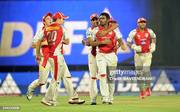 Kings XI Punjab bowler Parvinder Awana celebrates with his teammates after taking the wicket of Delhi Daredevils batsman Ross Taylor during the IPL...