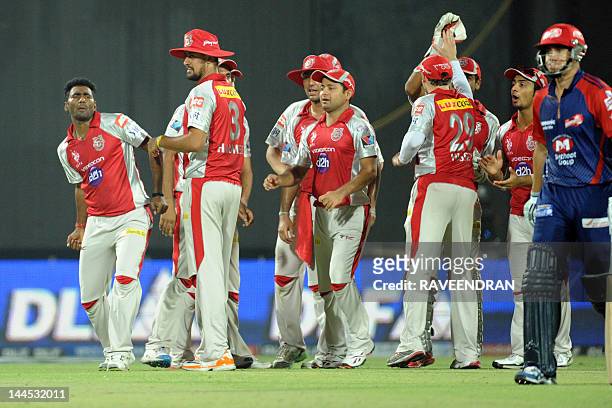 Kings XI Punjab bowler Parvinder Awana celebrates with his teammates after taking the wicket of Delhi Daredevils batsman Ross Taylor on May 15, 2012...