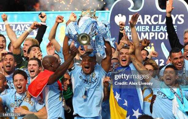 Vincent Kompany the captain of Manchester City lifts the Barclays Premier League trophy following the Barclays Premier League match between...