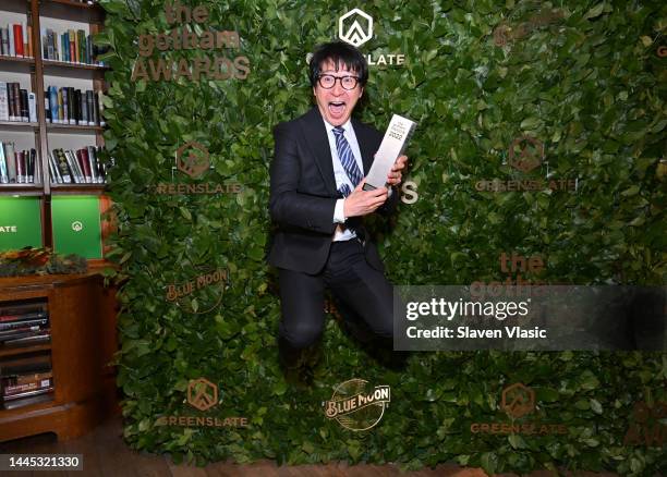 Ke Huy Quan poses with the Outstanding Supporting Performance Award in the GreenSlate Greenroom At The 2022 Gotham Awards at Cipriani Wall Street on...