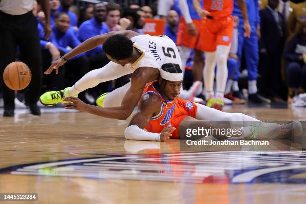 Herbert Jones of the New Orleans Pelicans and Shai Gilgeous-Alexander of the Oklahoma City Thunder go for a loose ball during the second half at...