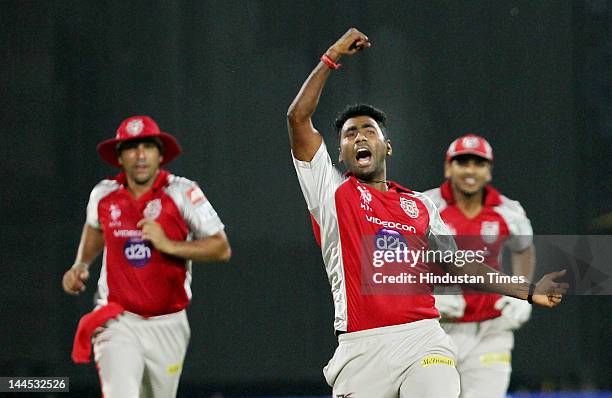 Kings XI Punjab bowler Parvinder Awana celebrates the dismissal of Delhi Daredevils Captain Virendra Sehwag during the IPL cricket match between...