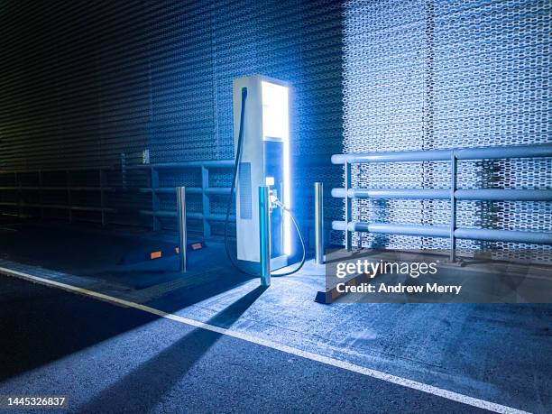 electric vehicle ev charging station at night glowing light - electric vehicle charging station stock pictures, royalty-free photos & images