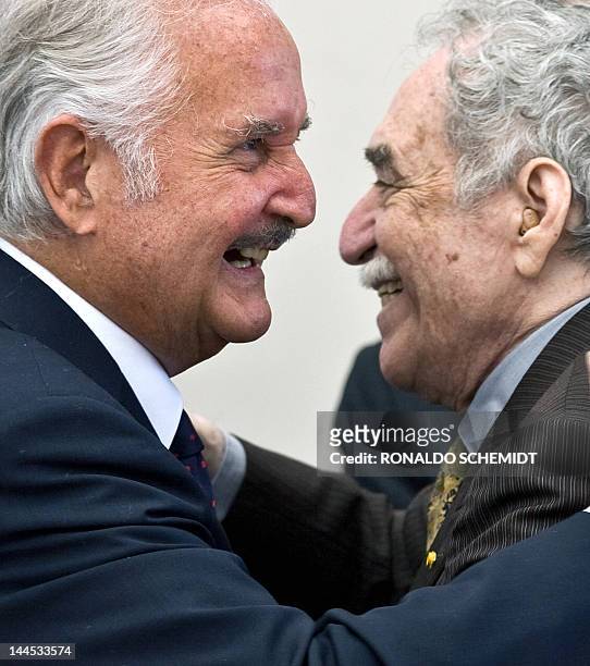 Mexican writer Carlos Fuentes is congratulated by Nobel Prize winner Colombian writer Gabriel Garcia Marquez during a celebration for Fuentes' 80th...