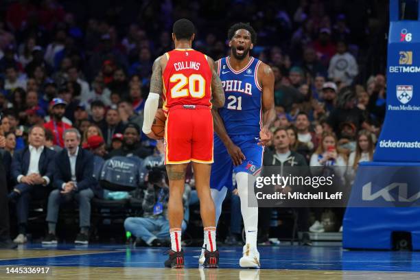 Joel Embiid of the Philadelphia 76ers reacts in front of John Collins of the Atlanta Hawks at the Wells Fargo Center on November 28, 2022 in...