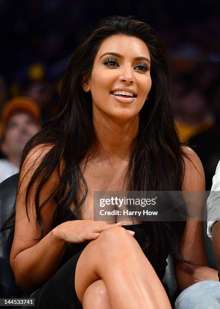 Kim Kardashian and Kanye West watch the video board from their courtside seats as the Los Angeles Lakers take on the Denver Nuggets in Game Seven of...