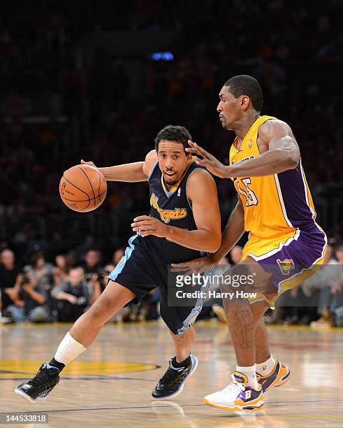 Andre Miller of the Denver Nuggets drives on Metta World Peace of the Los Angeles Lakers in Game Seven of the Western Conference Quarterfinals in the...