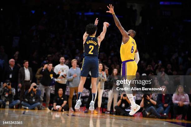 Andrew Nembhard of the Indiana Pacers hits a three point buzzer-beater over LeBron James of the Los Angeles Lakers to win the game 116-115 at...