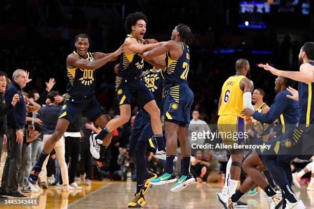 Andrew Nembhard of the Indiana Pacers celebrates with his teammates after hitting a three point buzzer-beater over LeBron James of the Los Angeles...