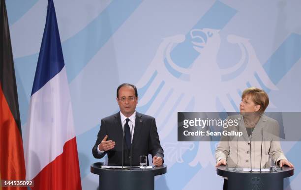 German Chancellor Angela Merkel and French President Francois Hollande speak to the media following talks at the Chancellery hours after Hollande's...