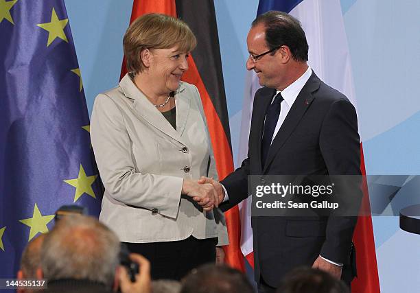 German Chancellor Angela Merkel and French President Francois Hollande depart after speaking to the media following talks at the Chancellery hours...