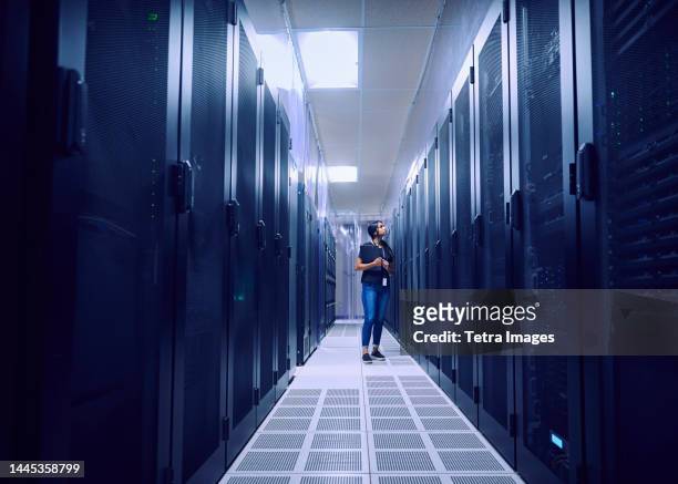 female technician working in server room - computer server room stock pictures, royalty-free photos & images