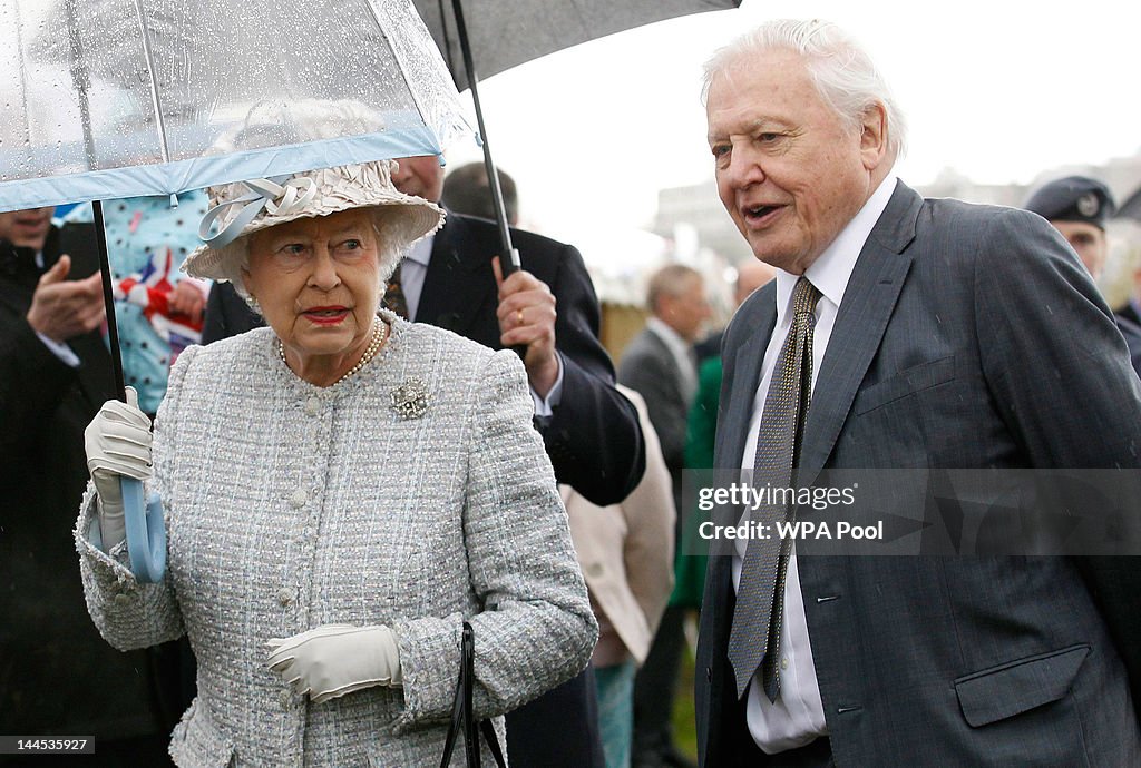 Queen Elizabeth II walks with broadcaster David Attenborough during a ...