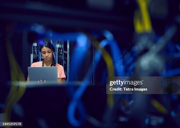 female technician using laptop in server room - server room ストックフォトと画像